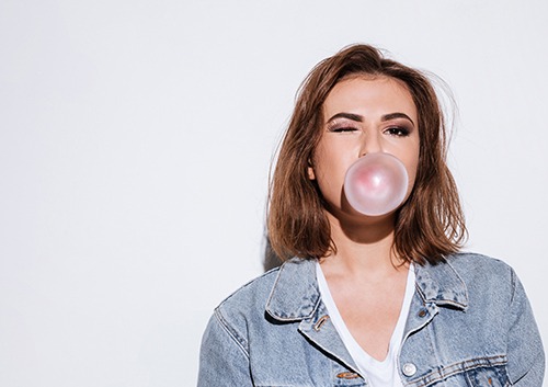woman blowing bubble gum